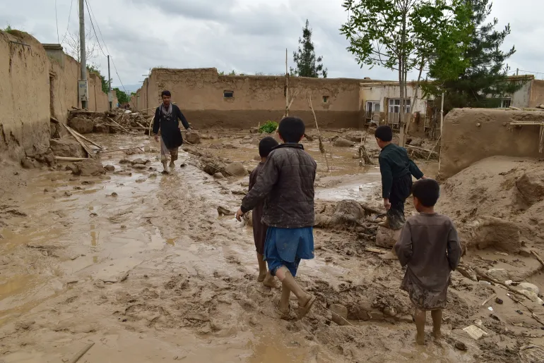 Children in Afghanistan, trekking through mud during the floods, Photo credit: Al Jazeera